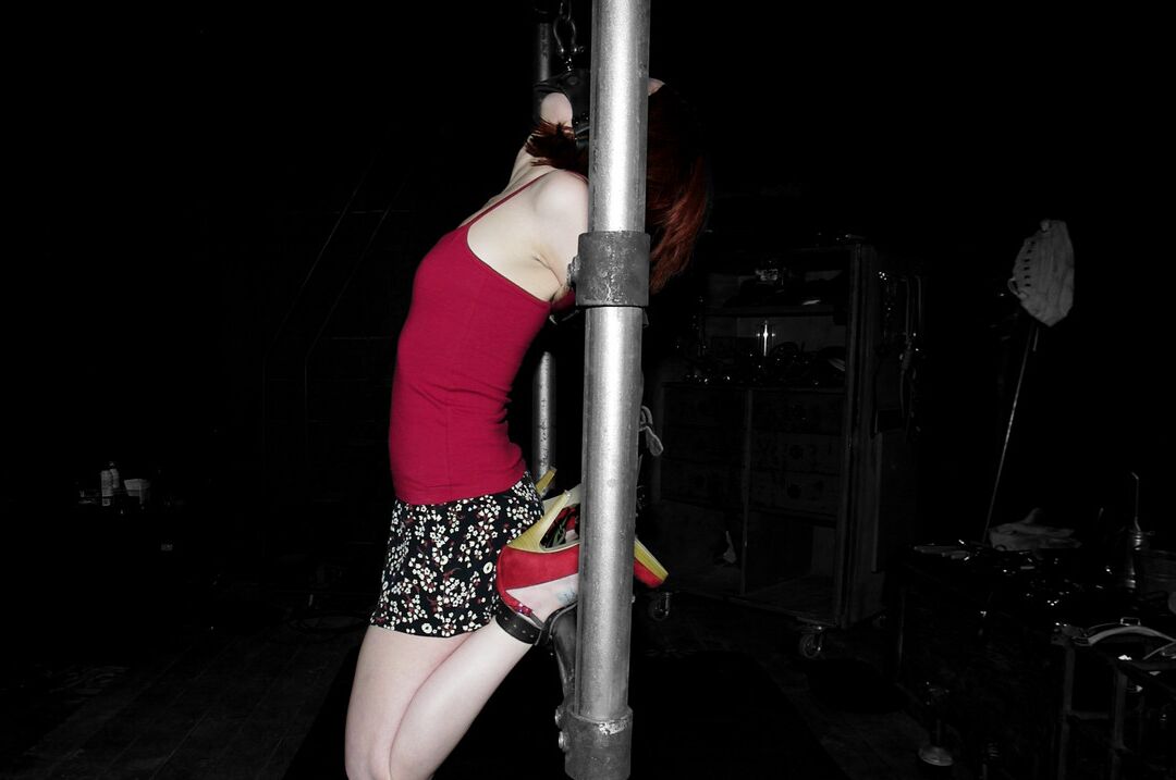19P Redheaded MILF Sabrina Sparx gets stripped while tied to a metal construction