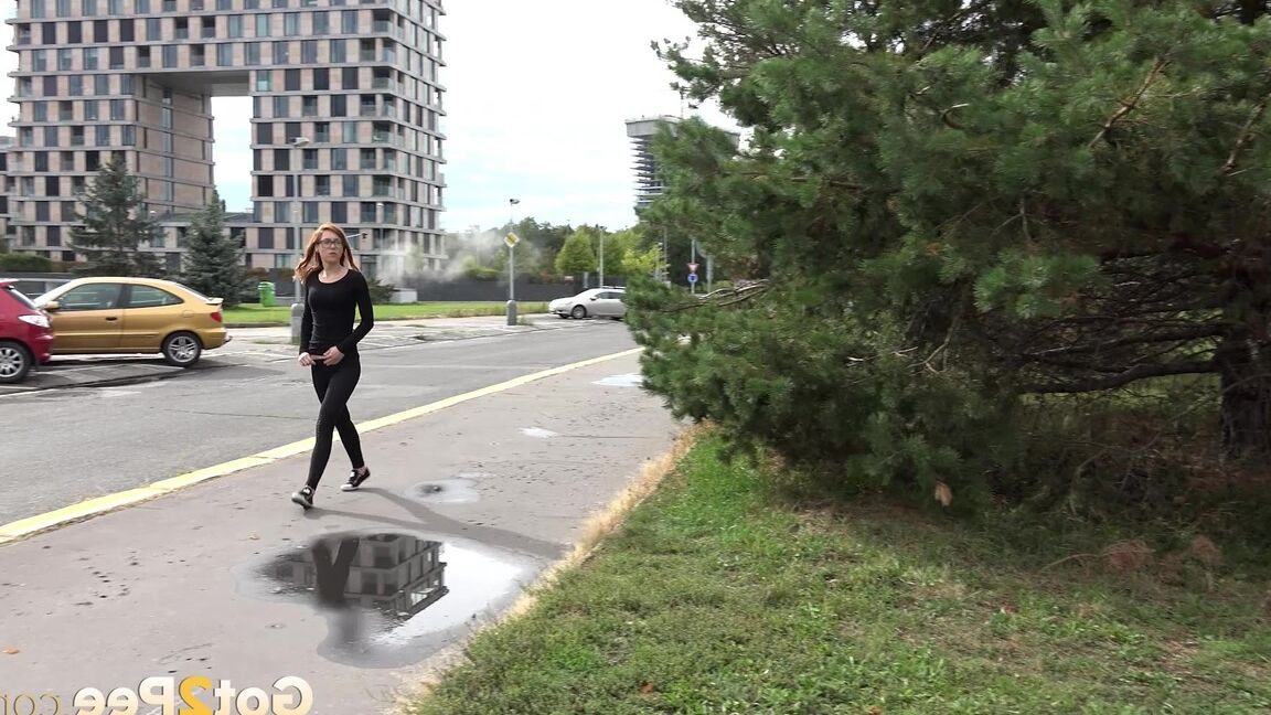 15P Black clad Sandra in glasses pauses to pee behind some trees on the street