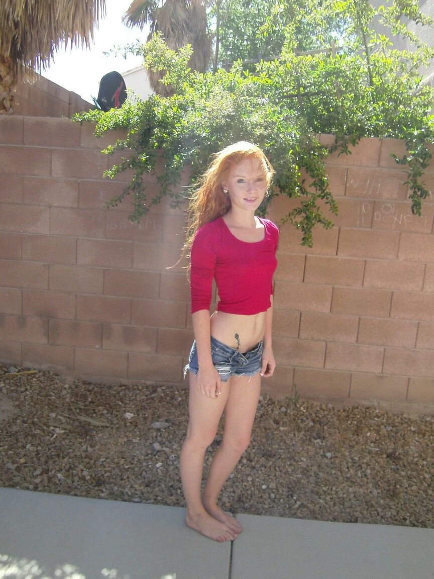 16P Redhead teen girl Alex Tanner flashes her tiny tits and ass against a wall