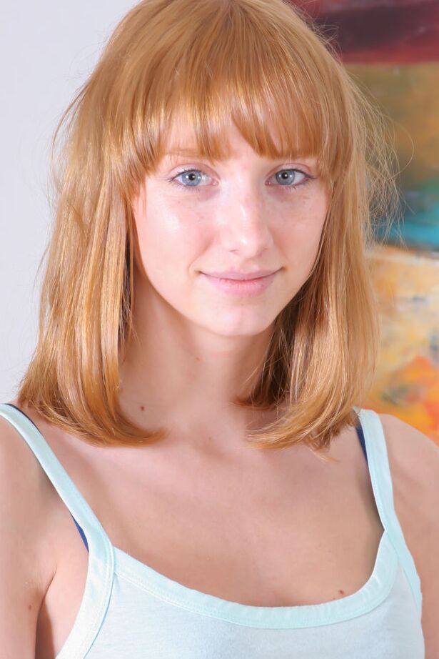 16P Barely legal redhead Rhea F gets totally naked on a leather sofa