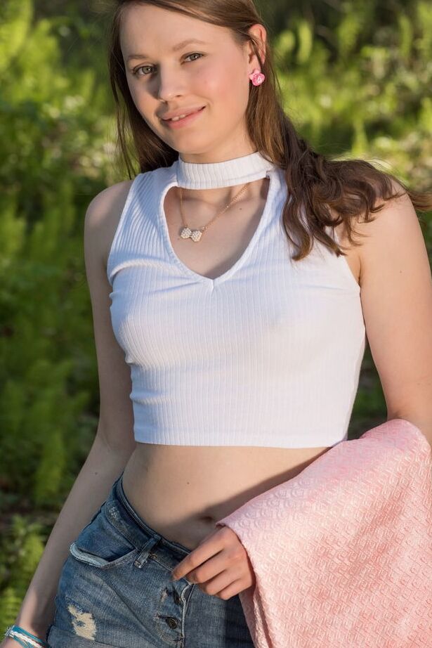 18P Leggy redhead Motya removes denim shorts to pose naked in the woods