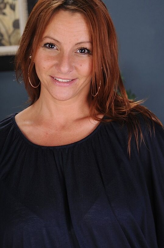 15P Redheaded MILF Gia Sophia stands naked after performing a striptease