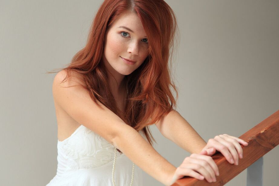 12P Alluring redhead Mia Sollis doffs white lingerie before petting shaved pussy