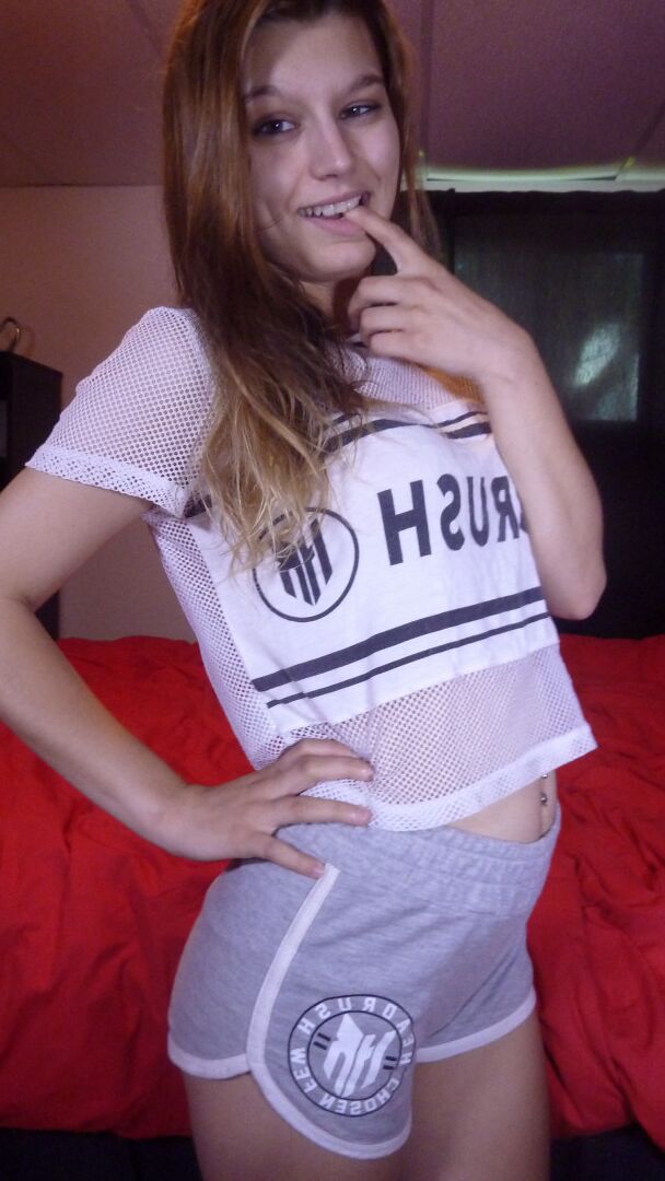 20P Young redhead gets dressed after posing in the nude and licking a penis