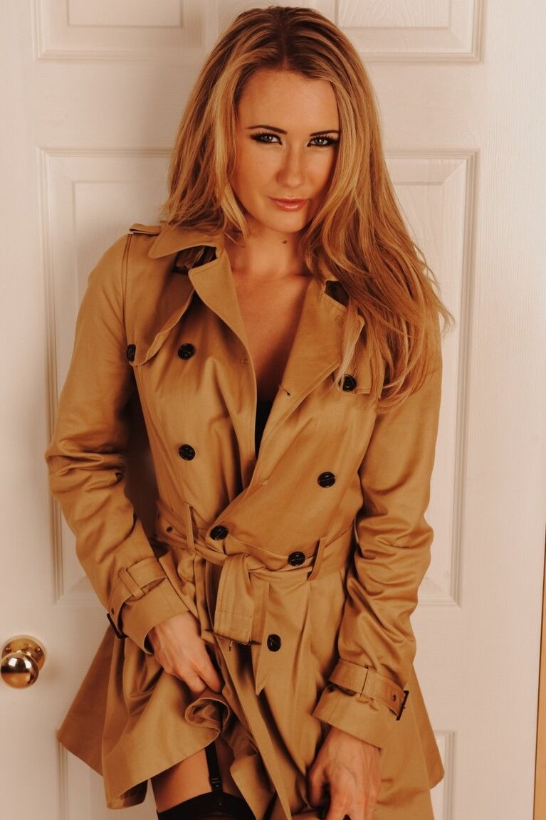 12P British glamour model Sam Tye doffs an overcoat in garters and nylons
