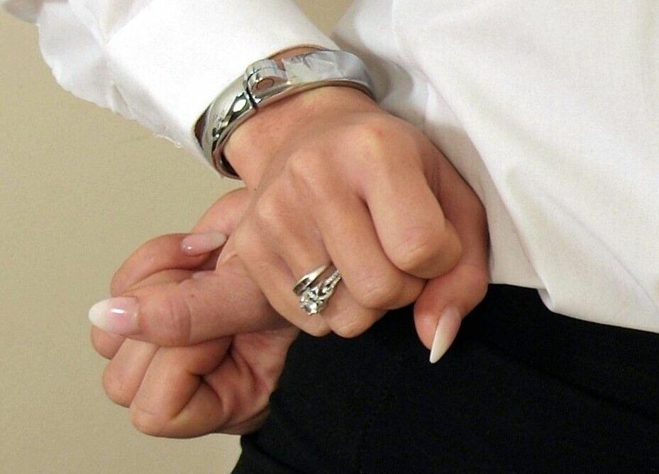 16P Collared British woman Natalia Forrest has her hands cuffed behind her back