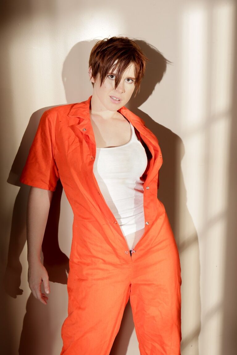 15P Redhead with short hair Lily Cade works free of clothes up against a wall