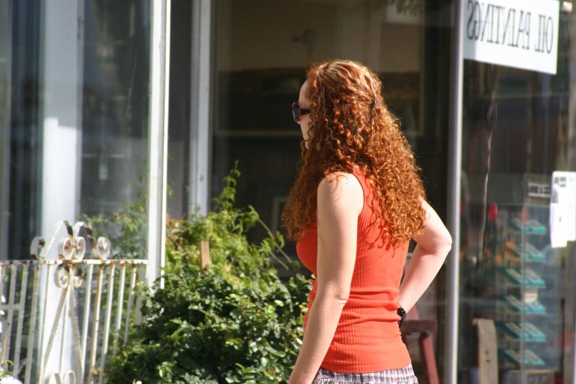 17P Redhead vixen Kitty Caulfield shows long legs in a short skirt in public