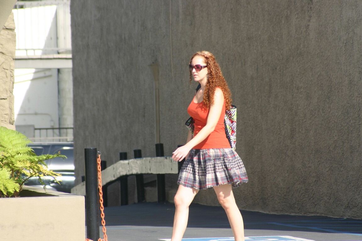 17P Redhead vixen Kitty Caulfield shows long legs in a short skirt in public