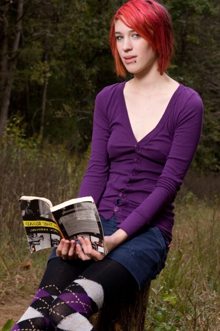 15P Redhead chick exposes upskirt pussy and tits while sitting on a stump