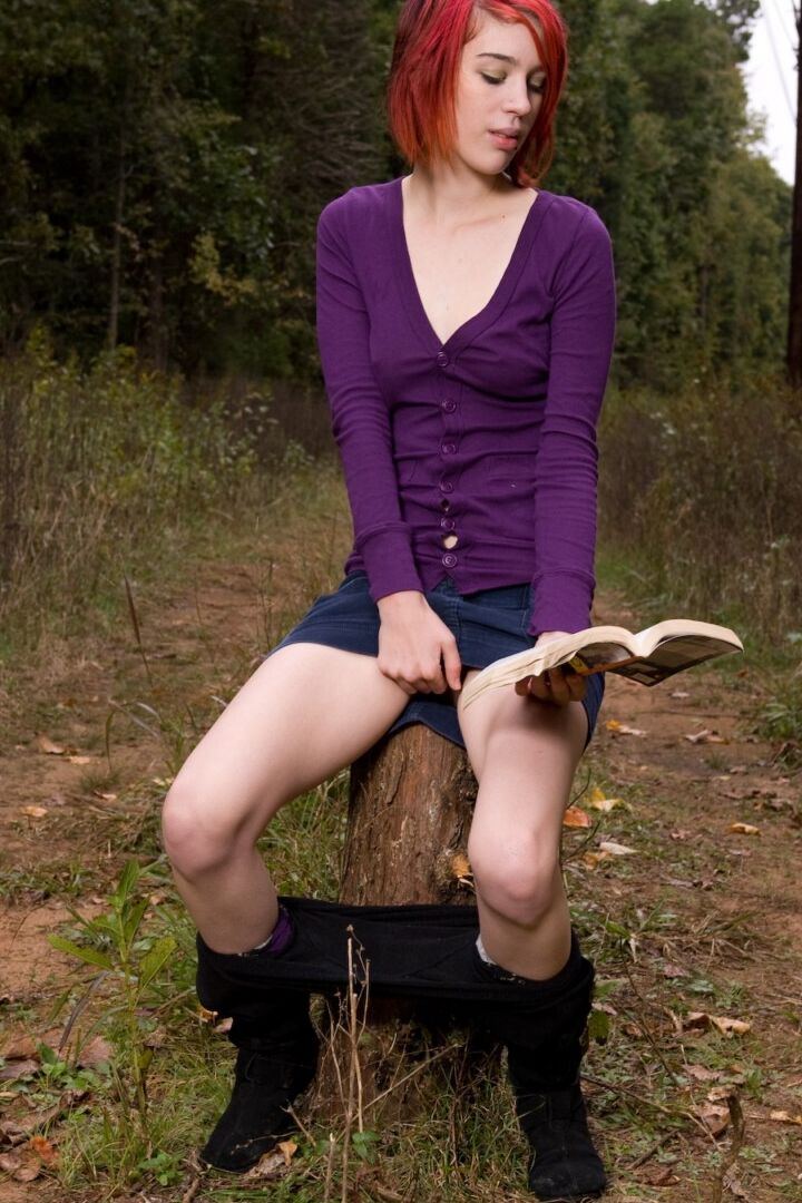 15P Redhead chick exposes upskirt pussy and tits while sitting on a stump