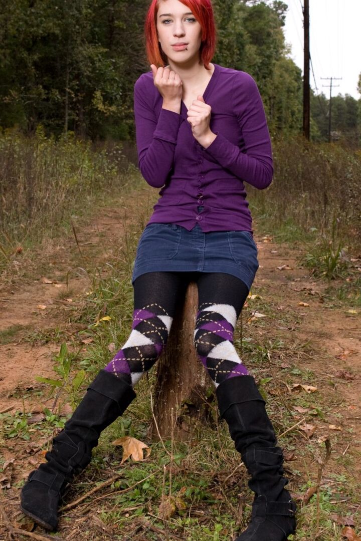 15P Redhead chick exposes upskirt pussy and tits while sitting on a stump