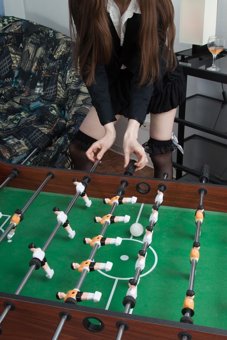 21P Petite Rose Nore strips & spreads her hairy pussy while playing table soccer