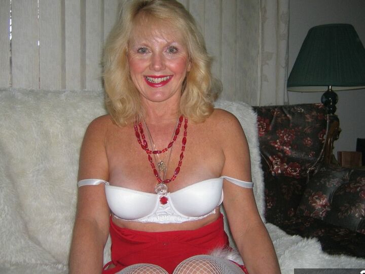 20P Aged blonde amateur Ruth plays with a cock before getting nude in Xmas hosiery