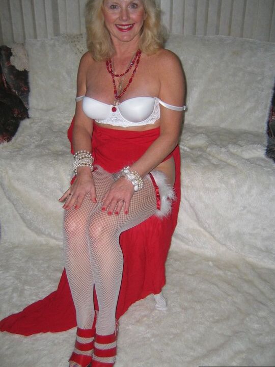 20P Aged blonde amateur Ruth plays with a cock before getting nude in Xmas hosiery