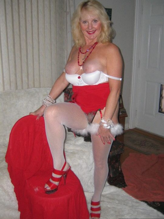 20P Aged blonde amateur Ruth plays with a cock before getting nude in Xmas hosiery
