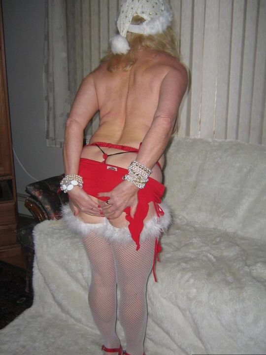 20P Aged blonde amateur Ruth plays with a cock before getting nude in Xmas hosiery