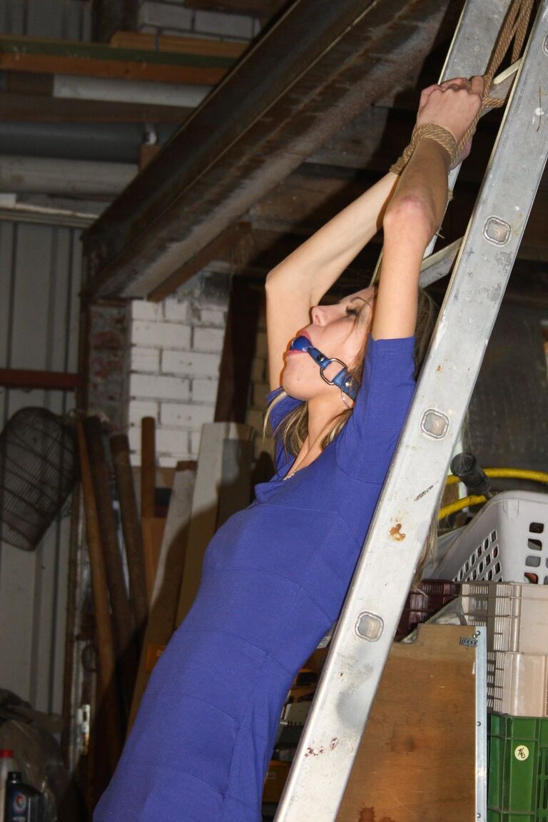 17P Amateur blonde Irena gagged & tied fully clothed to a ladder for garage grope