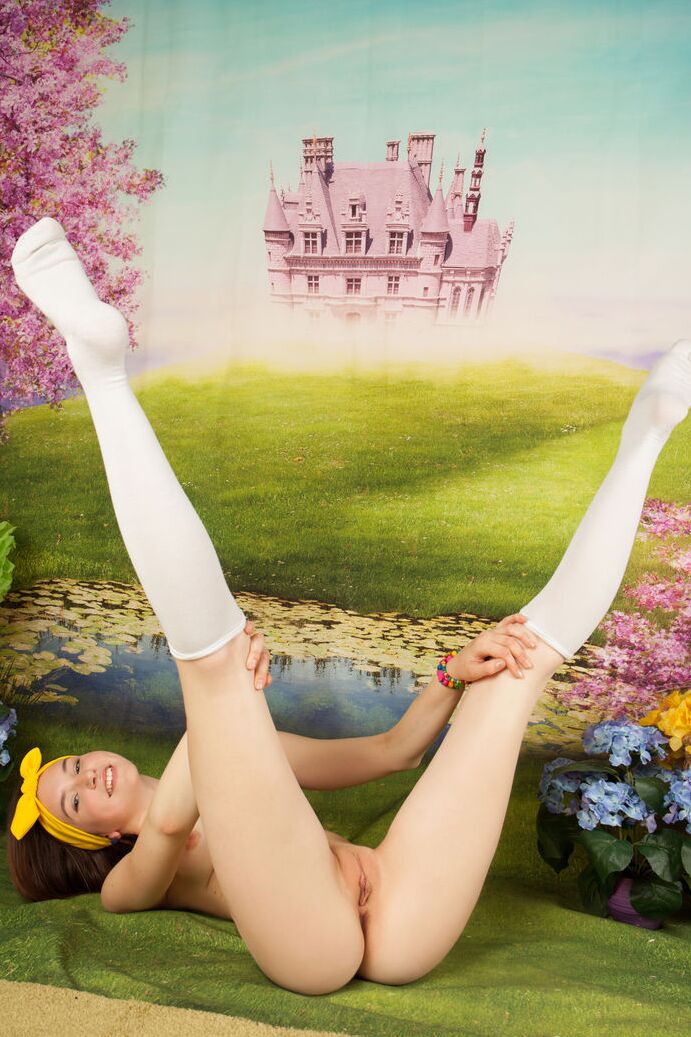 20P Young looking redhead Slava shows off her lithe body in a bow and knee socks
