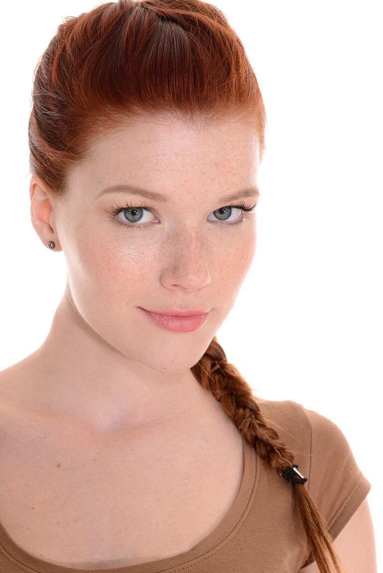 15P Sexy redhead Mia Sollis does a slow striptease before crossing her long legs