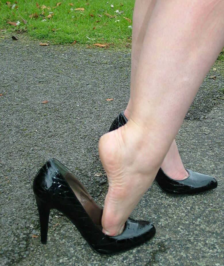 16P Fully clothed model Nicola takes a walk on park pathway in her new black pumps