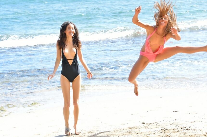 16P 2 lesbians frolic in swimsuits at the beach before strolling in the nude