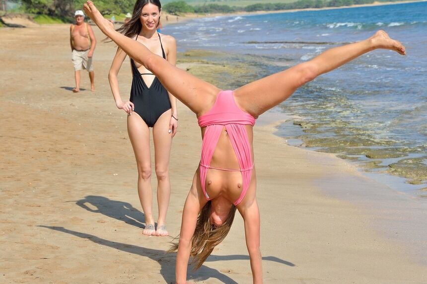 16P 2 lesbians frolic in swimsuits at the beach before strolling in the nude