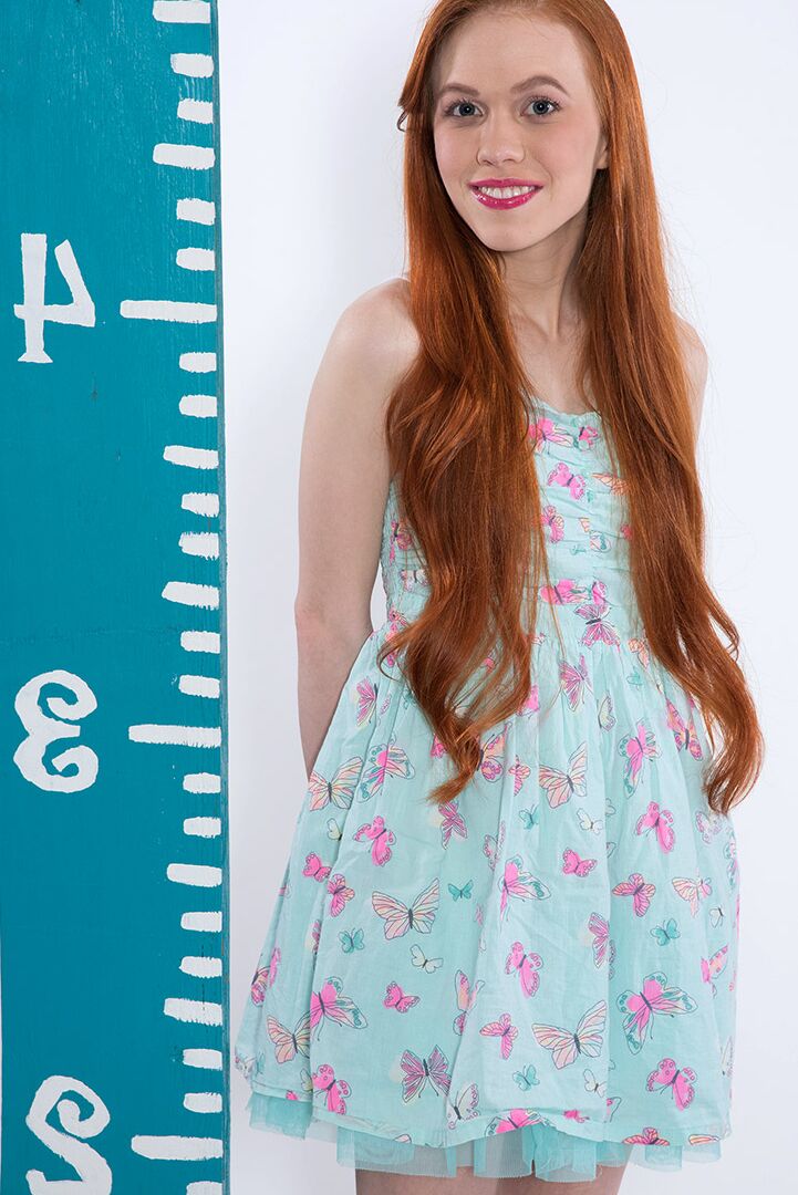 16P Young looking redhead Dolly Little uncovers her small tits in cute panties