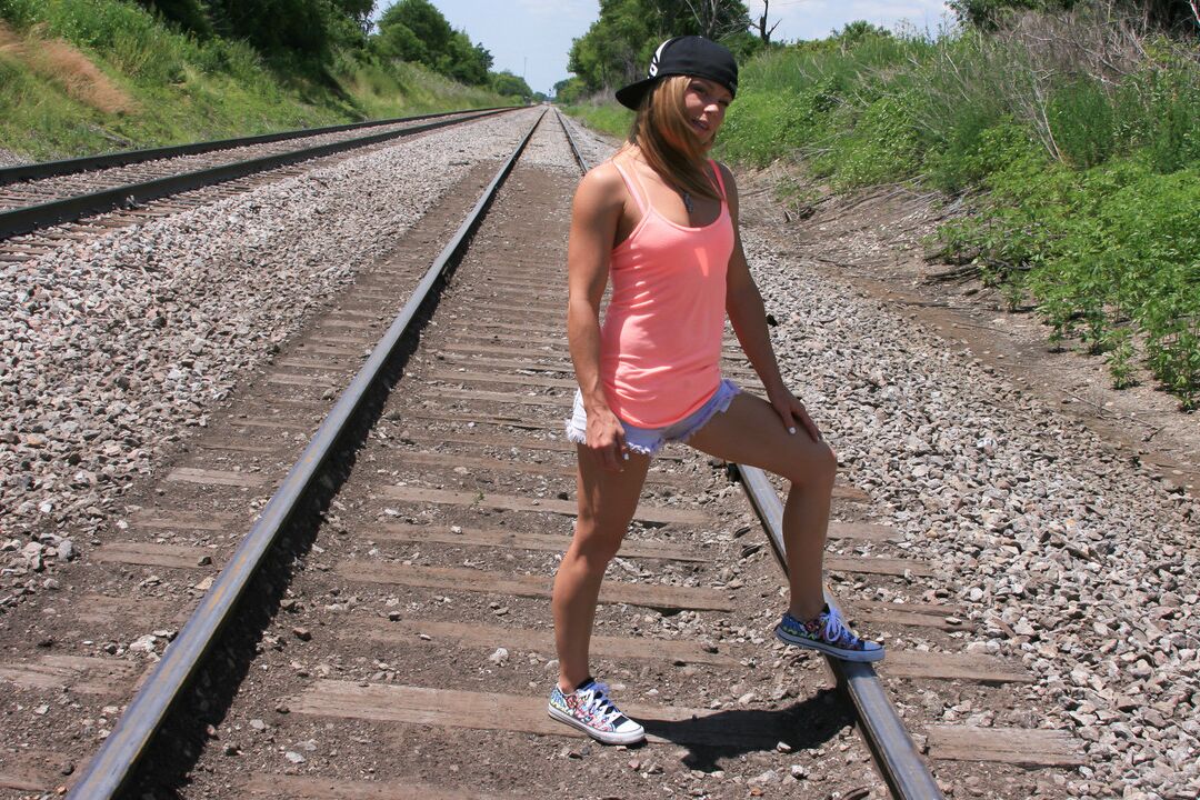 15P Amateur girl Meet Madden goes topless on train tracks in a backwards ball cap