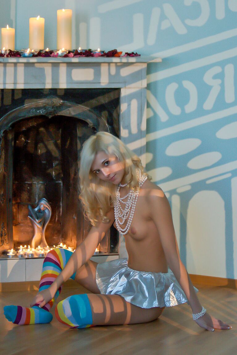 16P Barely legal blonde Eyra U strikes tempting poses in over the knee socks