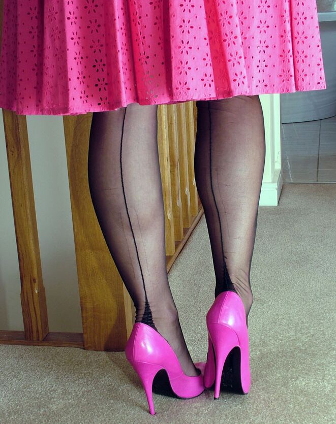 16P Blue eyed blonde models backseam nylons in pink pumps and a matching dress