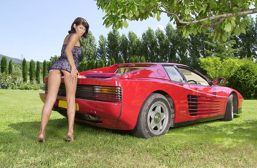 21P A deslumbrante MILF húngara Jade Wolf fica nua e posa em um carro vermelho ao ar livre