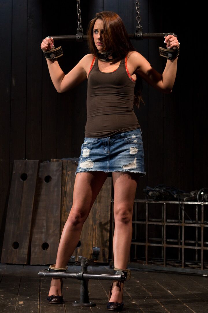 21P Brunette babe Hope Howell gets whipped while chained up in metal bondage
