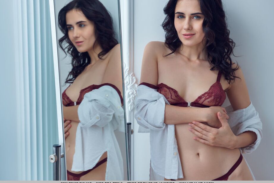 18P Dark haired teen Mona gets totally naked in front of a mirror on a wall
