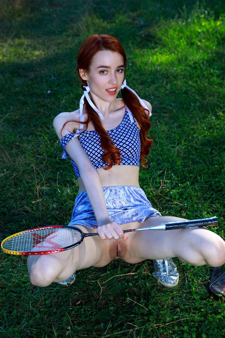 21P Redheaded teen with small tits Sherice unveils her sweet muff in a park
