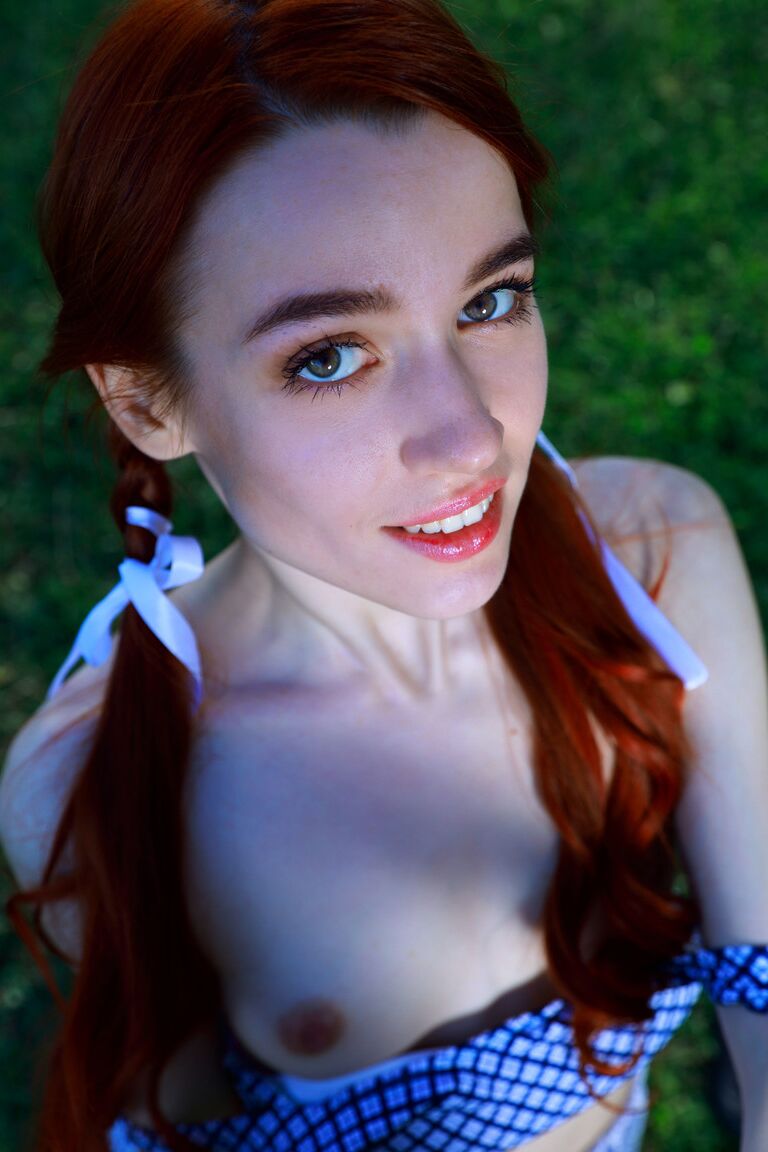 21P Redheaded teen with small tits Sherice unveils her sweet muff in a park