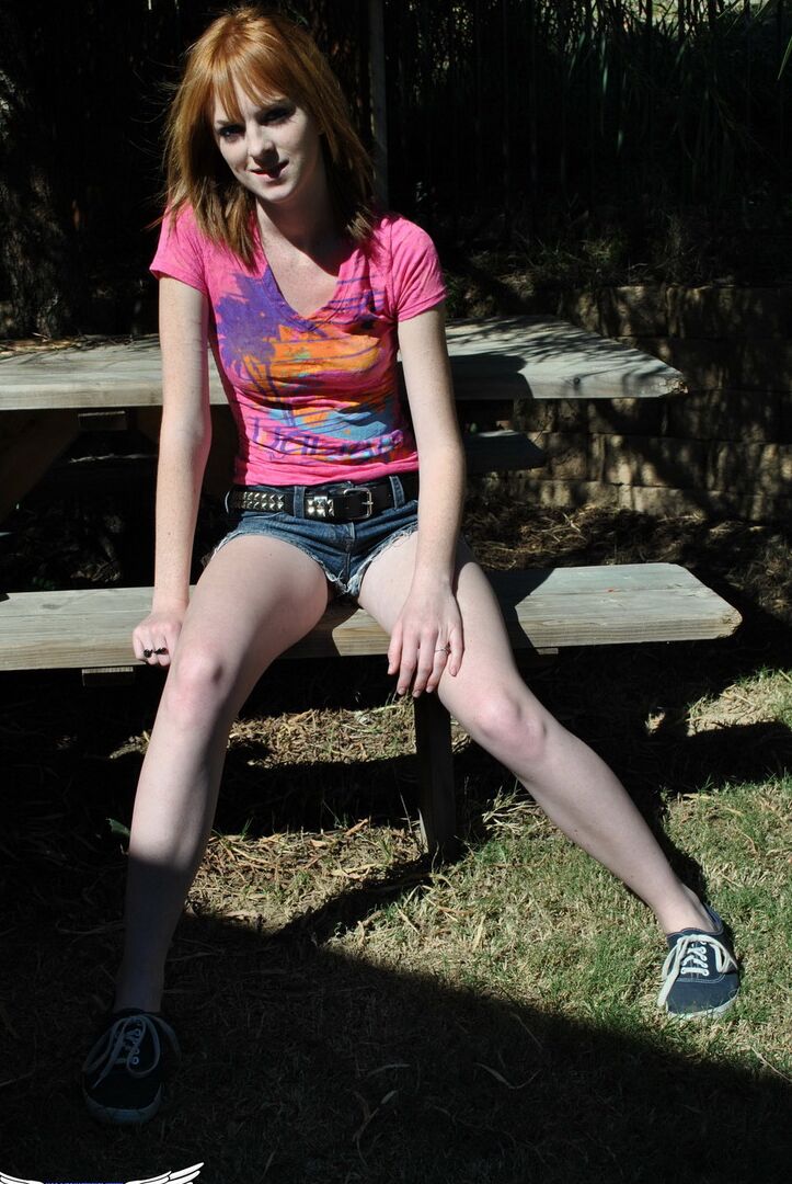 12P Young redhead Kate Cooper hikes her skirt and flashes her twat against a fence