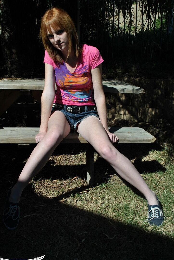 12P Young redhead Kate Cooper hikes her skirt and flashes her twat against a fence