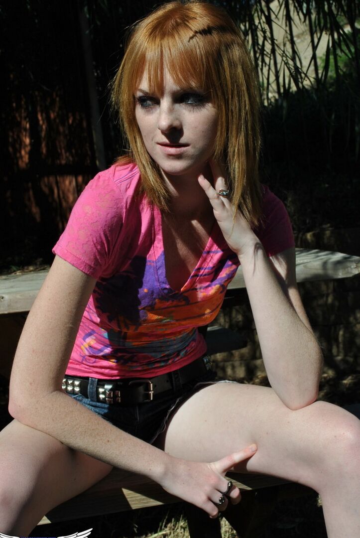 12P Young redhead Kate Cooper hikes her skirt and flashes her twat against a fence