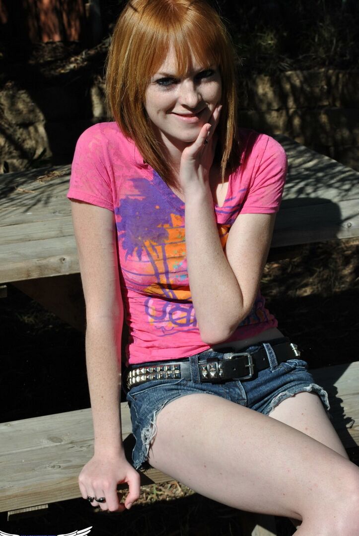 12P Young redhead Kate Cooper hikes her skirt and flashes her twat against a fence