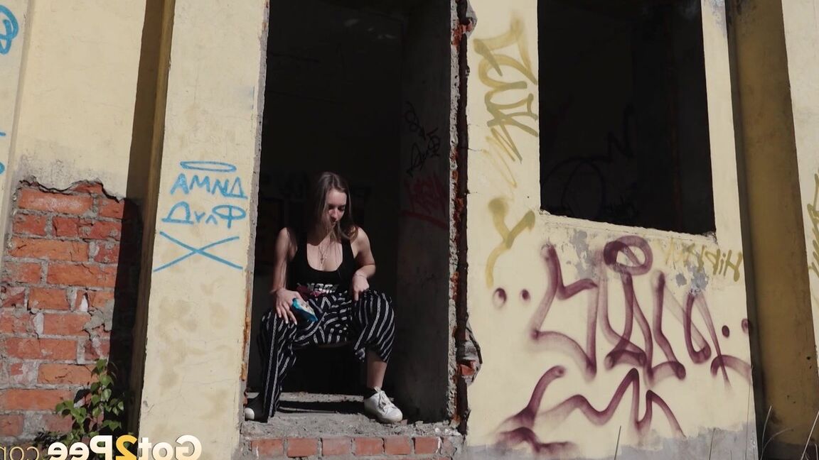 15P Sexy babe squats in abandoned building to piss