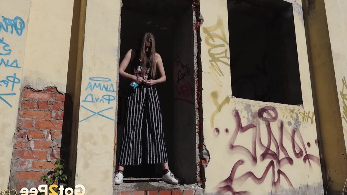 15P Sexy babe squats in abandoned building to piss