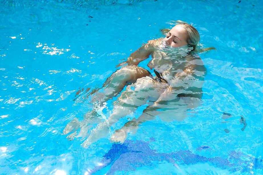 16P Leggy blonde Christen is sitting at the poolside and playing with puss