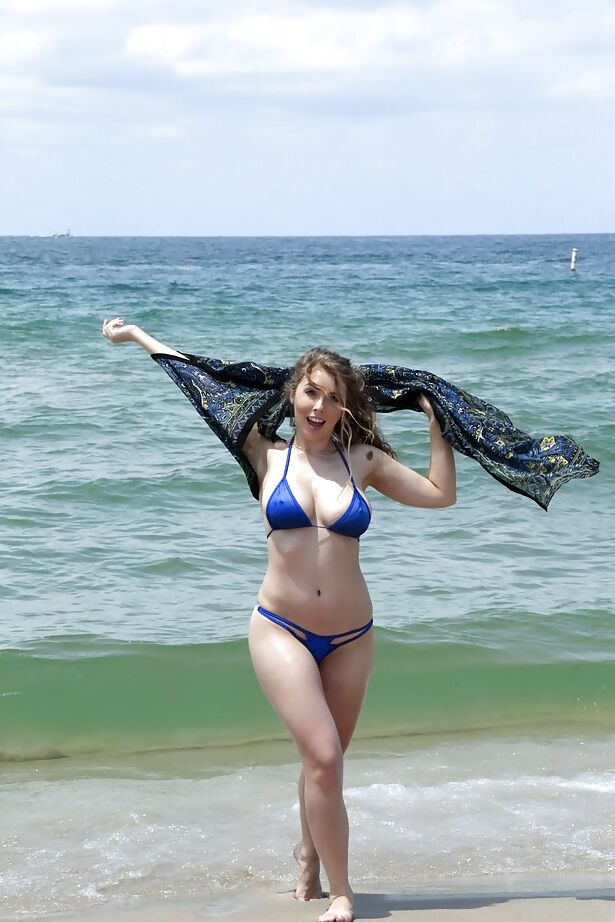 15P Beach babe Lena Paul freeing nice melons from bikini by swimming pool