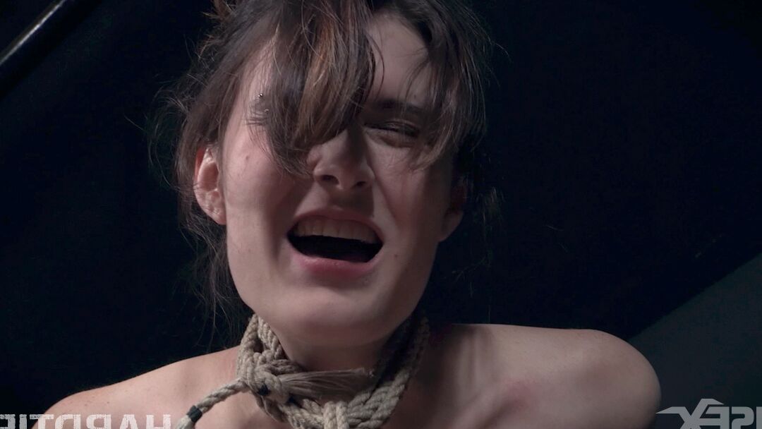 14P Naked female Sosha Belle is gagged and suspended by ropes in a dungeon