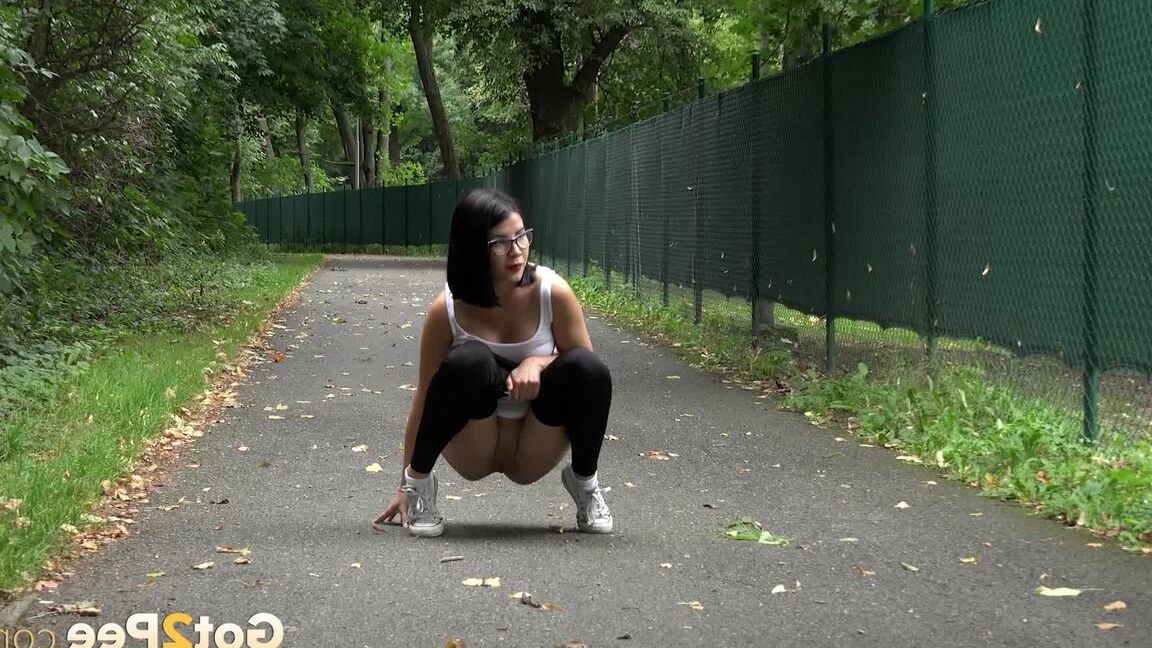 15P Glasses wearing chick pulls down her legging for a quick piss on on paved lot