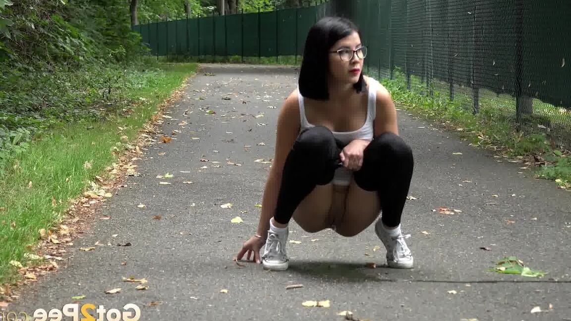 15P Glasses wearing chick pulls down her legging for a quick piss on on paved lot