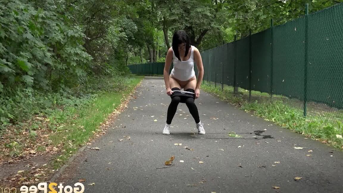 15P Glasses wearing chick pulls down her legging for a quick piss on on paved lot