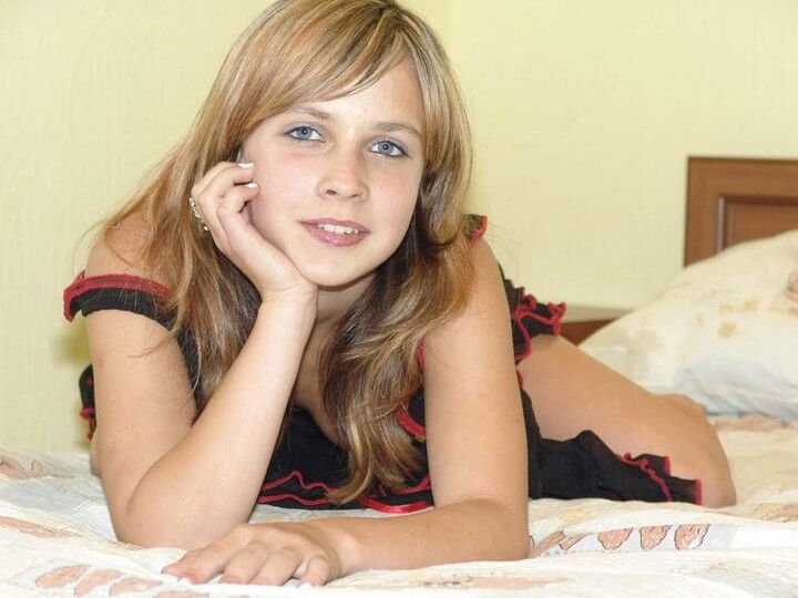 20P La douce adolescente Liza pousse ses seins fermes vers l'avant après avoir retiré sa lingerie transparente.