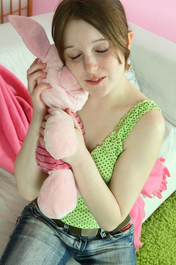 16P Sweet young girl Angela uncovers her tiny tits while playing with a plush toy